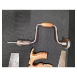 Antique tools. 3 vintage hand saws and 1 ratcheting brace drill