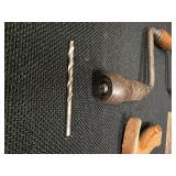 Antique tools. 3 vintage hand saws and 1 ratcheting brace drill