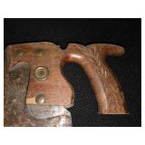 Antique tools. 3 vintage hand saws and 1 ratcheting brace drill