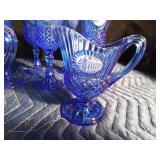 9 Blue Avon goblets and 3 small blue Avon pitchers