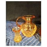 Gold colored glass pitcher, 6 mugs, small drinking glass and 1 brown pitcher