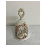 Collection of Holiday Figurines and Decor Including Angel, Nativity Egg, Bells, and Winter Children