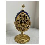 Collection of Holiday Figurines and Decor Including Angel, Nativity Egg, Bells, and Winter Children