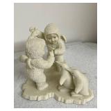 Collection of Holiday Figurines and Decor Including Angel, Nativity Egg, Bells, and Winter Children