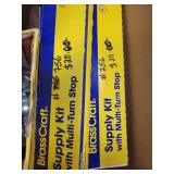Box of BrassCraft Supply Kits and Green Pipe Clamps