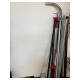 Workshop Equipment and Material Collection with Hand Tools, Shelving, Metal Sheets, and Clamps