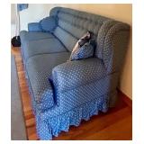 Blue Upholstered Sofa, Chair, and Ottoman Set with Skirted Detailing and Area rug