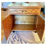 Rolling Oak Storage Cabinet with Drawer and Shelves
