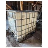 Used oil container and two barrels