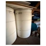 Used oil container and two barrels