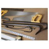 Collection of Hand Tools Including Saws, Crowbars, and Square