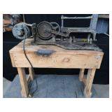 POWER HACK SAW ON HEAVY DUTY WOOD BENCH.