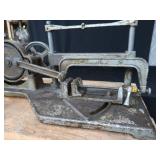 POWER HACK SAW ON HEAVY DUTY WOOD BENCH.