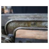 POWER HACK SAW ON HEAVY DUTY WOOD BENCH.