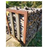 Stack of Seasoned Firewood in Metal Rack