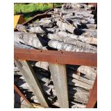 Stack of Seasoned Firewood in Metal Rack
