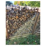 Stack of Seasoned Firewood in Metal Rack