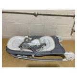 Ingenuity Gas Relief and Anti-Colic Baby Bouncer Seat and Rocker, Gentle Belly Message to Relax and Soothe Bellies, Instant Tummy Soother, 20 Songs and Melodies  Chambray Blue