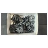 Assorted Electronics and Accessories Including Brookstone Alarm Clock, Power Supplies, Cables, and Power Strip