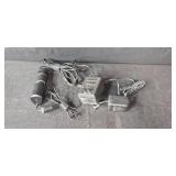 Assorted Electronics and Accessories Including Brookstone Alarm Clock, Power Supplies, Cables, and Power Strip