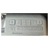 Assorted Electronics and Accessories Including Brookstone Alarm Clock, Power Supplies, Cables, and Power Strip
