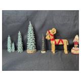 Holiday Decor Collection with Carved Trees, Straw Goat, and Merry Christmas Santa Figure