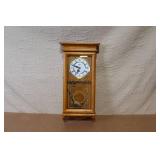 Wall Mount Pendulum Clock with Oak Finish and Roman Numeral Dial