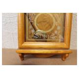 Wall Mount Pendulum Clock with Oak Finish and Roman Numeral Dial