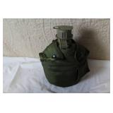 Military Surplus Collection with Ammo Cans, First Aid Kit, Boots, and Memorabilia