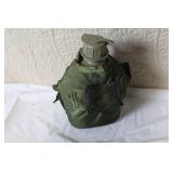 Military Surplus Collection with Ammo Cans, First Aid Kit, Boots, and Memorabilia