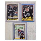 Lot of 3 Wayne Gretzky Hockey Cards including O-Pee-Chee and Topps sets with highlights and milestone stats