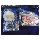 Lot of keychains, bottle openers and sunglasses