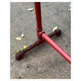 Red Metal Pipe Frame Clothing Stand and Roll of Perforated Metal Red Metal Pipe Frame Clothing Stand and Roll of Perforated Metal