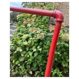 Red Metal Pipe Frame Clothing Stand and Roll of Perforated Metal Red Metal Pipe Frame Clothing Stand and Roll of Perforated Metal