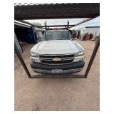 2007 White Chevy 3500 Diesel truck, flatbed with side rails, rack extending over the cab