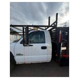 2007 White Chevy 3500 Diesel truck, flatbed with side rails, rack extending over the cab