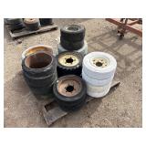 Pallet of Industrial tires and rims, likely for heavy yard equipment
