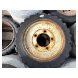 Pallet of Industrial tires and rims, likely for heavy yard equipment