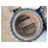 Pallet of Industrial tires and rims, likely for heavy yard equipment