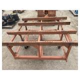 Heavy-duty industrial rolling cart probably designed for transporting pipes or beams 62 ¾” l x 48” w x 33”