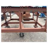 Heavy-duty industrial rolling cart probably designed for transporting pipes or beams 62 ¾” l x 48” w x 33”