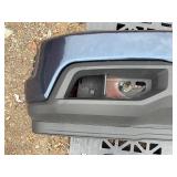 Vehicle Front Bumper Assembly w/ fog light openings, license plate mounting bracket and two-tone color scheme.