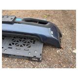 Vehicle Front Bumper Assembly w/ fog light openings, license plate mounting bracket and two-tone color scheme.