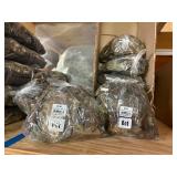 3 shelves of camo/orange hunting gear. Jackets, sweatshirts, hats, foam footballs