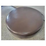 A Modern Round Brown Leather Coffee Table / Ottoman by Room and Board.