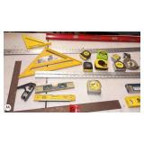 Assorted Measuring and Layout Tools including Tape Measures, Levels, and Squares