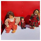 Lot of 3 Porcelain Dolls Including One with Curly Hair and One with Holiday Attire