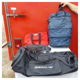 Adidas Black Duffel, Grey Gym Bag, Blue Carry-On, and Red Tote Bag.