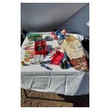 Assorted household and miscellaneous items including fabrics, salsa mix, weights, tobacco tubes, and small tools
