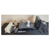 Collection of Xfinity Modems, Cisco Cable Boxes, USB Charger, Remotes, and Decorative Clock